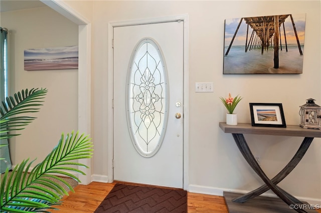 entryway with baseboards and wood finished floors