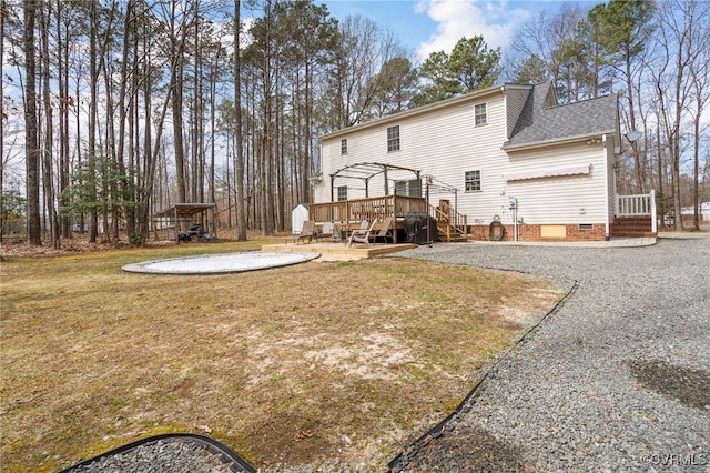 back of property with crawl space, a lawn, a deck, and a shingled roof