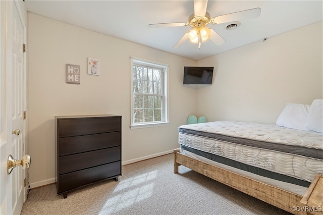 bedroom with visible vents, baseboards, light colored carpet, and ceiling fan