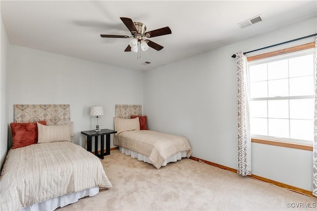 bedroom featuring visible vents, baseboards, ceiling fan, and carpet flooring