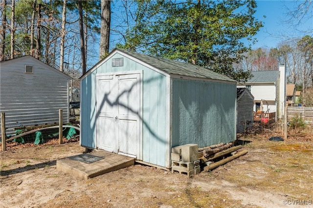 view of shed with fence