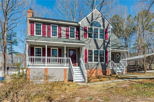 view of front of property featuring crawl space, roof with shingles, a porch, and a chimney