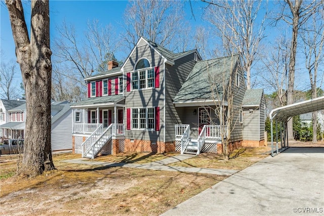 view of front of property with crawl space, a porch, concrete driveway, a chimney, and a carport