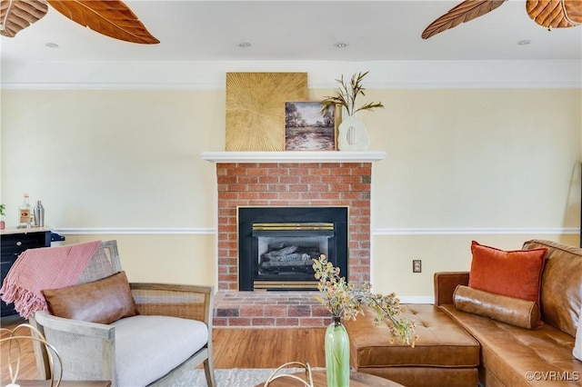 living area featuring recessed lighting, a brick fireplace, and ceiling fan