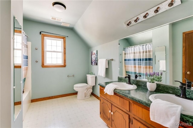 full bath featuring visible vents, toilet, a sink, double vanity, and vaulted ceiling