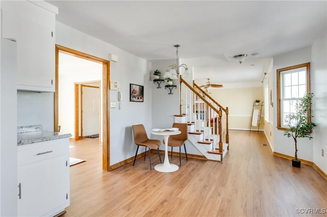 interior space with wood finished floors, baseboards, and a chandelier