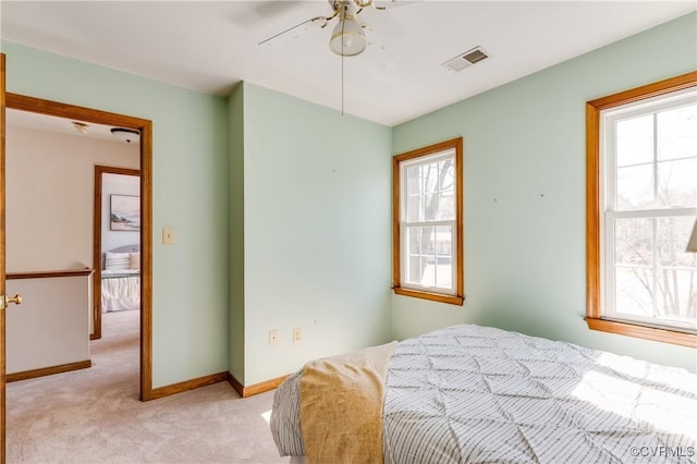 bedroom with light carpet, visible vents, and baseboards