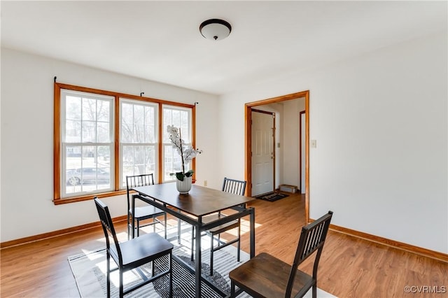 dining room with baseboards and light wood-style floors