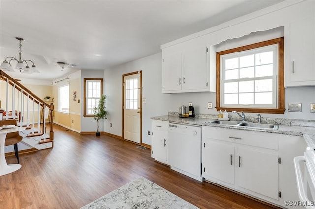 kitchen featuring dark wood-style floors, white dishwasher, a sink, stove, and white cabinetry