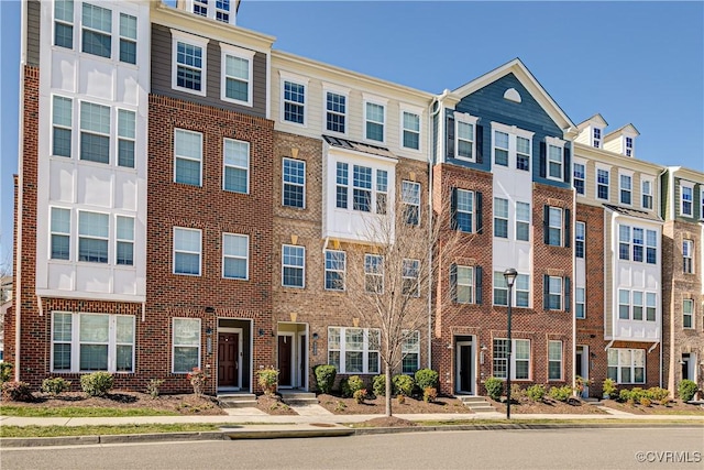 view of property featuring brick siding