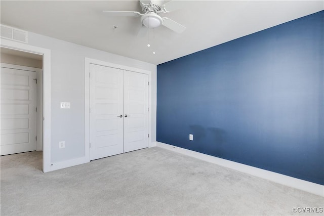 unfurnished bedroom with a closet, visible vents, baseboards, and carpet floors