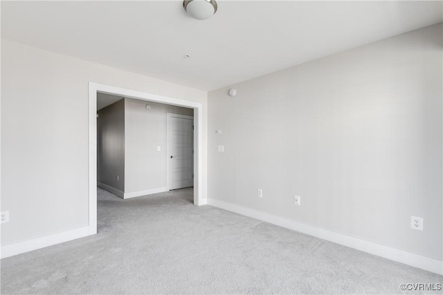 unfurnished room featuring baseboards and carpet floors