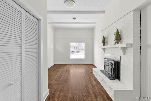 hallway with beamed ceiling, baseboards, visible vents, and dark wood-style flooring