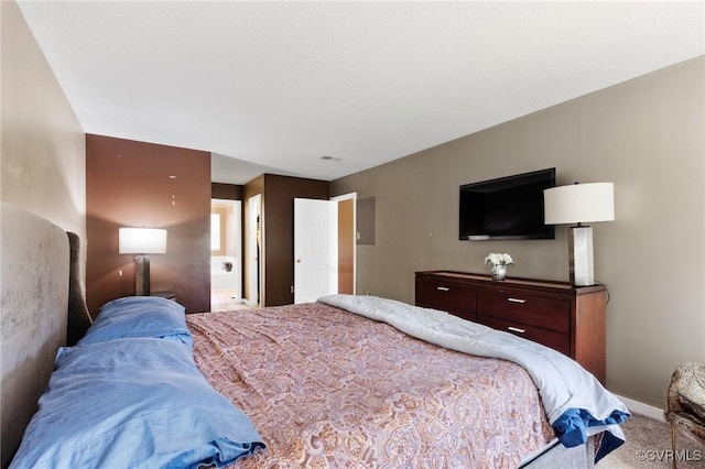 carpeted bedroom featuring baseboards