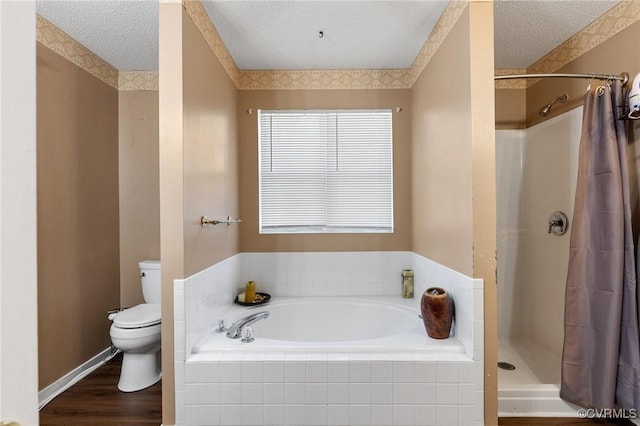 full bathroom featuring curtained shower, a garden tub, toilet, and a textured ceiling