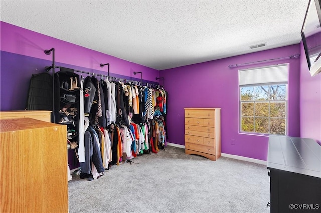 walk in closet with visible vents and carpet flooring