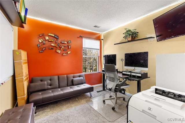 office area with visible vents, a textured ceiling, and baseboards