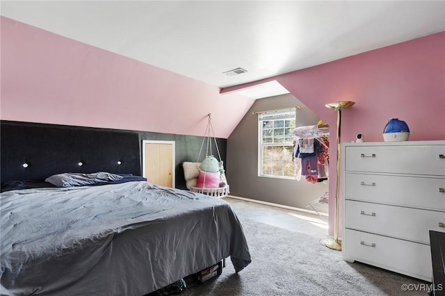 carpeted bedroom featuring visible vents and vaulted ceiling