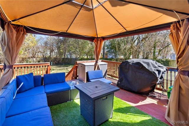 view of patio featuring grilling area, an outdoor living space, fence, a gazebo, and a deck