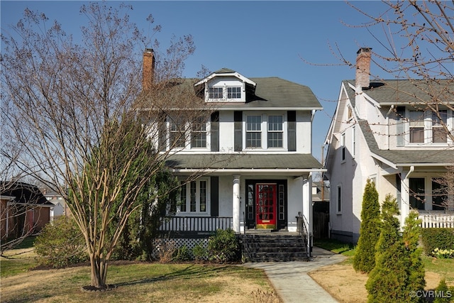 traditional style home with covered porch and stucco siding