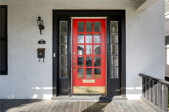 entrance to property featuring stucco siding