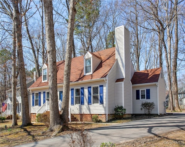 cape cod house featuring crawl space and a chimney