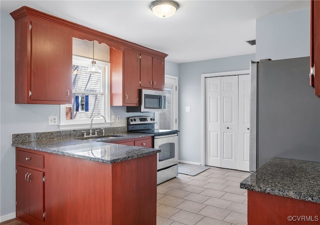 kitchen with visible vents, baseboards, appliances with stainless steel finishes, a peninsula, and a sink