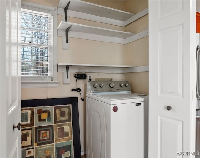 clothes washing area featuring washer / clothes dryer and laundry area