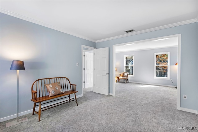 living area featuring visible vents, carpet, baseboards, and ornamental molding