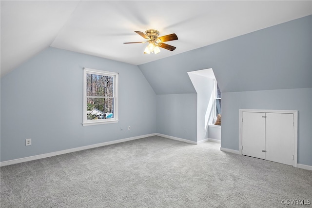 additional living space with baseboards, carpet floors, a ceiling fan, and vaulted ceiling