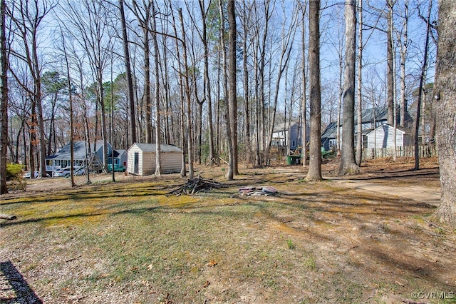 view of yard featuring an outbuilding and a shed