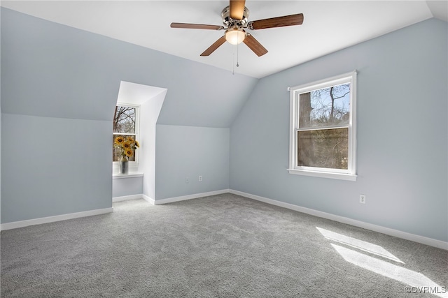 additional living space with baseboards, carpet floors, lofted ceiling, and ceiling fan