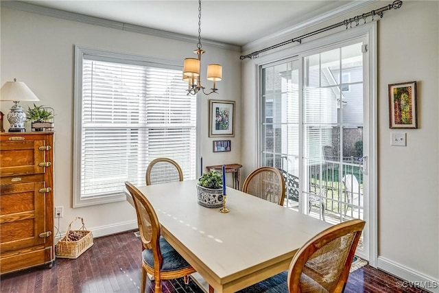 dining area with baseboards, a healthy amount of sunlight, dark wood finished floors, and crown molding