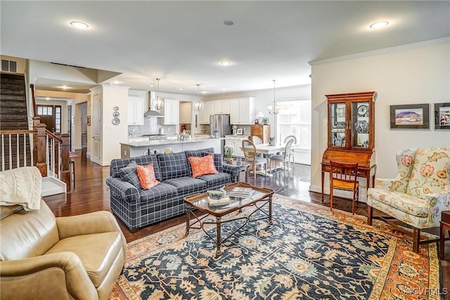 living area with stairway, recessed lighting, crown molding, and dark wood-type flooring