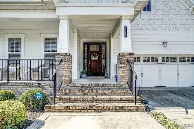 property entrance with driveway and a garage