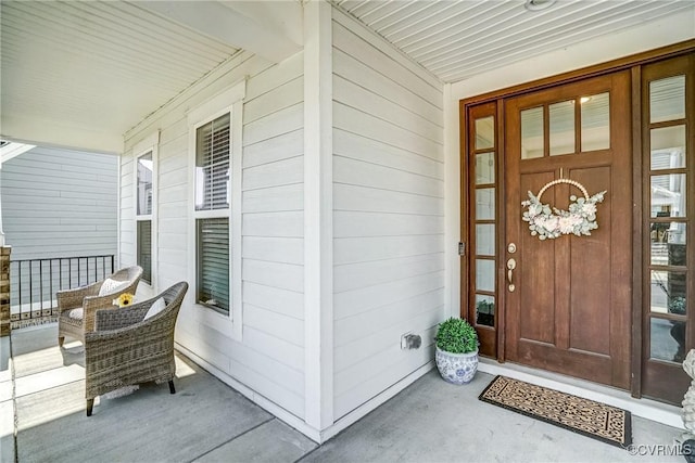 view of exterior entry with covered porch