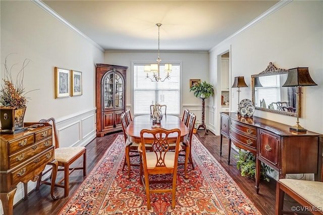 dining area featuring wainscoting, dark wood-type flooring, and ornamental molding