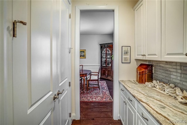 interior space with crown molding and dark wood-style flooring