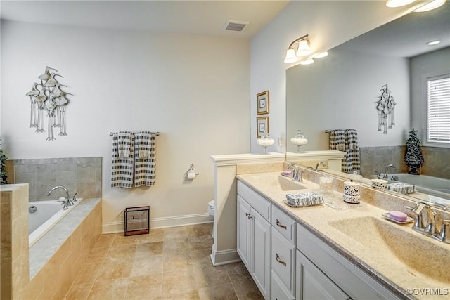 full bath featuring visible vents, toilet, a garden tub, a sink, and double vanity