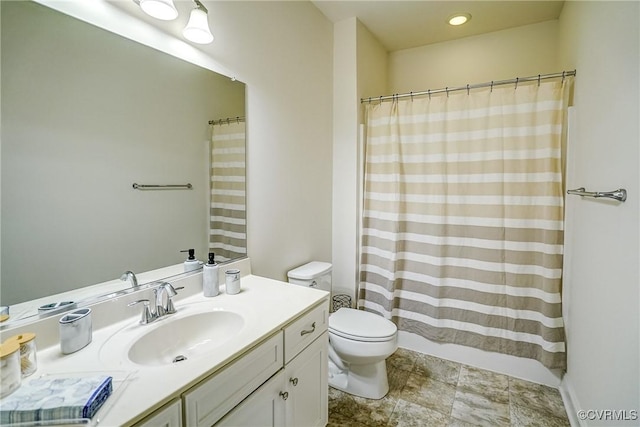 bathroom with toilet, vanity, and a shower with curtain