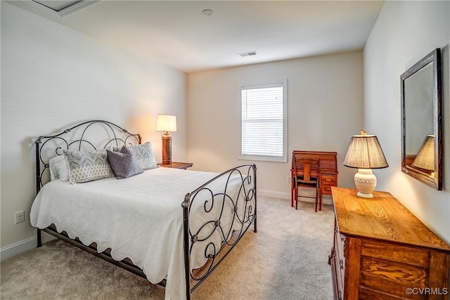 carpeted bedroom featuring visible vents and baseboards