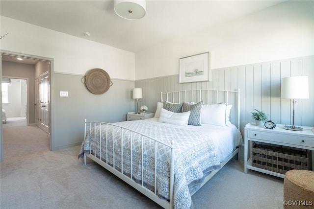 bedroom with wainscoting and carpet flooring