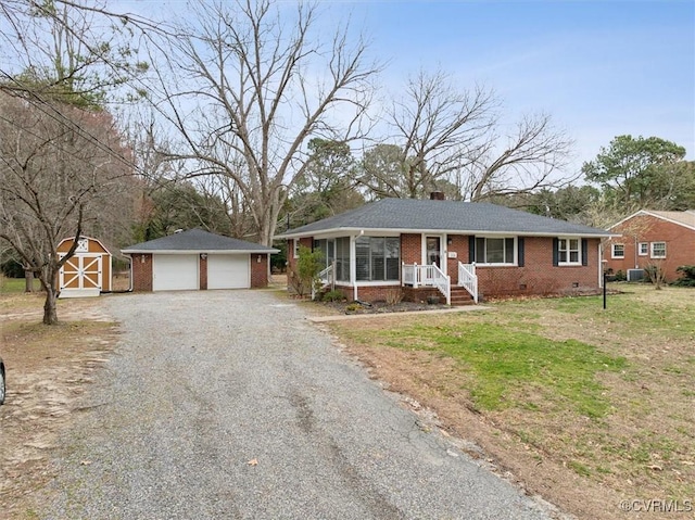 ranch-style home featuring brick siding, a chimney, a sunroom, crawl space, and an outbuilding