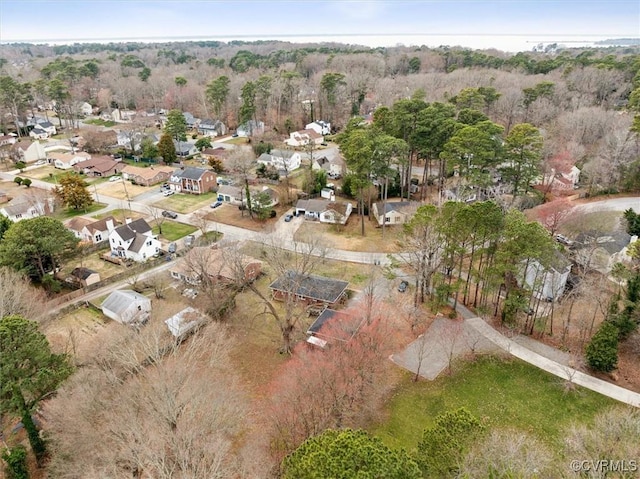 birds eye view of property with a residential view and a wooded view