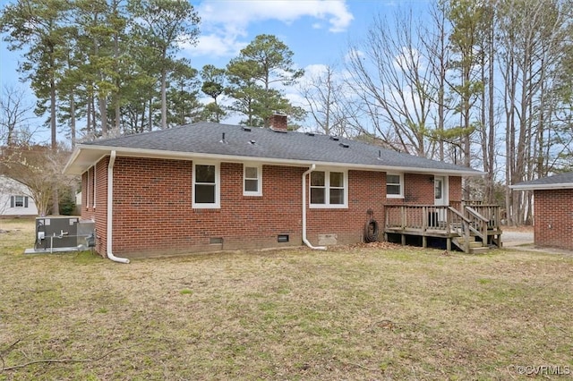 rear view of house featuring roof with shingles, a chimney, crawl space, a lawn, and brick siding