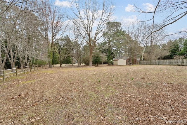 view of yard featuring an outbuilding and fence