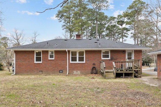 back of property with roof with shingles, a wooden deck, crawl space, brick siding, and a chimney