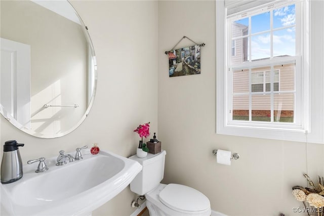 half bathroom featuring a sink and toilet