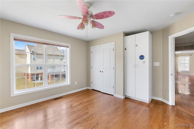 unfurnished bedroom featuring visible vents, light wood-type flooring, and baseboards