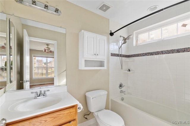 full bathroom featuring vanity, toilet, visible vents, and a wealth of natural light